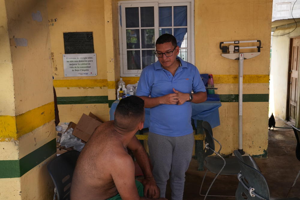 Dr. Ariel Garibaldi speaks with a patient at Bajo Chiquito's small public clinic, on Sept. 16. The clinic consists of two rooms and a patio that serves as a waiting area.
