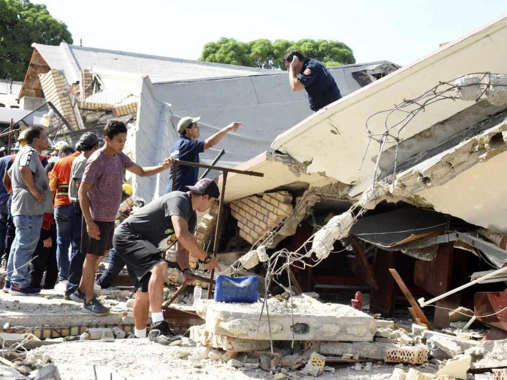 Rescue workers search for survivors amid debris after the roof of a church collapsed during a Sunday Mass in Ciudad Madero, Mexico, Sunday, Oct. 1, 2023.