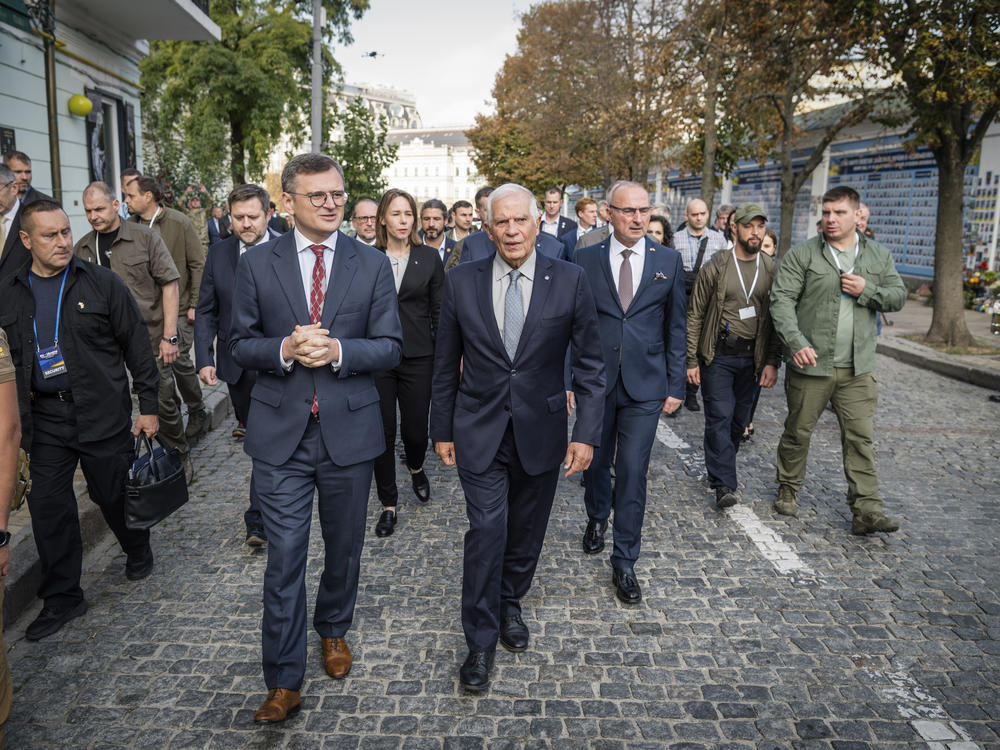 Ukrainian Foreign Minister Dmytro Kuleba (center left) and European Union foreign policy chief Josep Borrell visit a monument to fallen defenders of Ukraine in Kyiv, Monday. Borrell and EU foreign ministers have gathered in Kyiv in a display of support for Ukraine's fight against Russia's invasion.