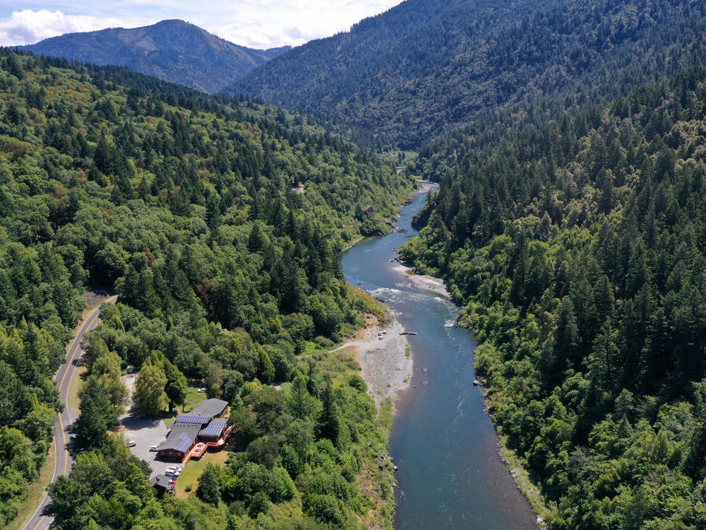 The Klamath River flows by the Yurok Tribe's headquarters in Weitchpec, Calif., June 9, 2021.