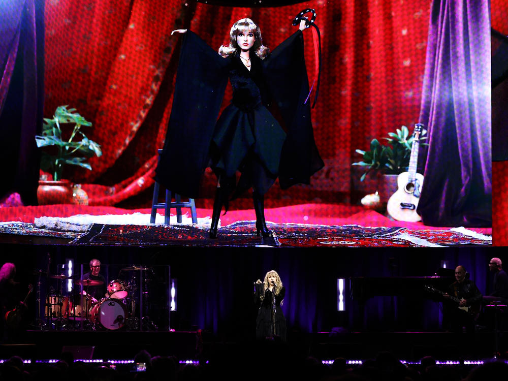 Stevie Nicks stands under an image of her new Barbie doll during a concert at New York City's Madison Square Garden on Sunday.