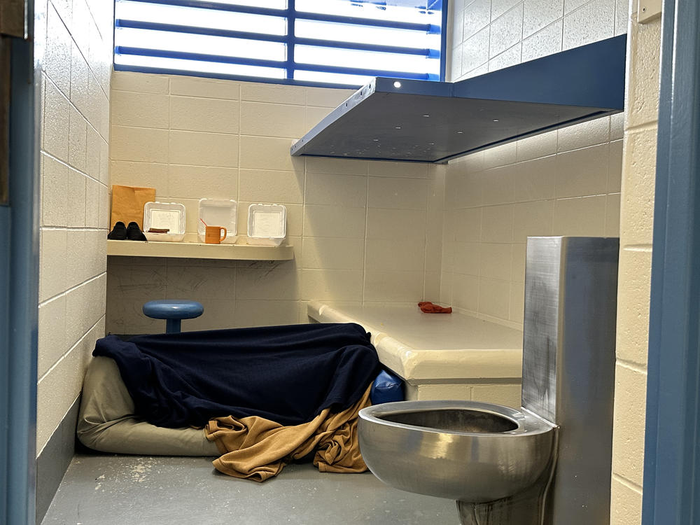 An unidentified woman lies under a blanket in a cell in the Flathead County Detention Center in Kalispell, Montana. She has been held there for nearly a year after being found mentally unfit to stand trial on burglary charges, according to a jail official.