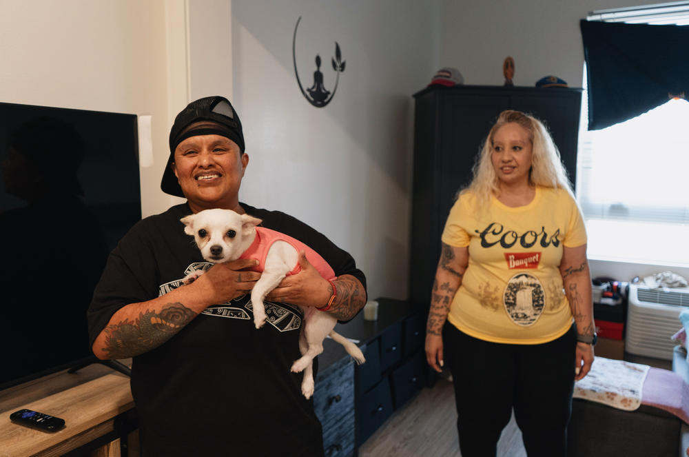 Dulce Volantin (left), Valarie Zayas and their dog, Zoey in their apartment. Their building has building with on-site case management.