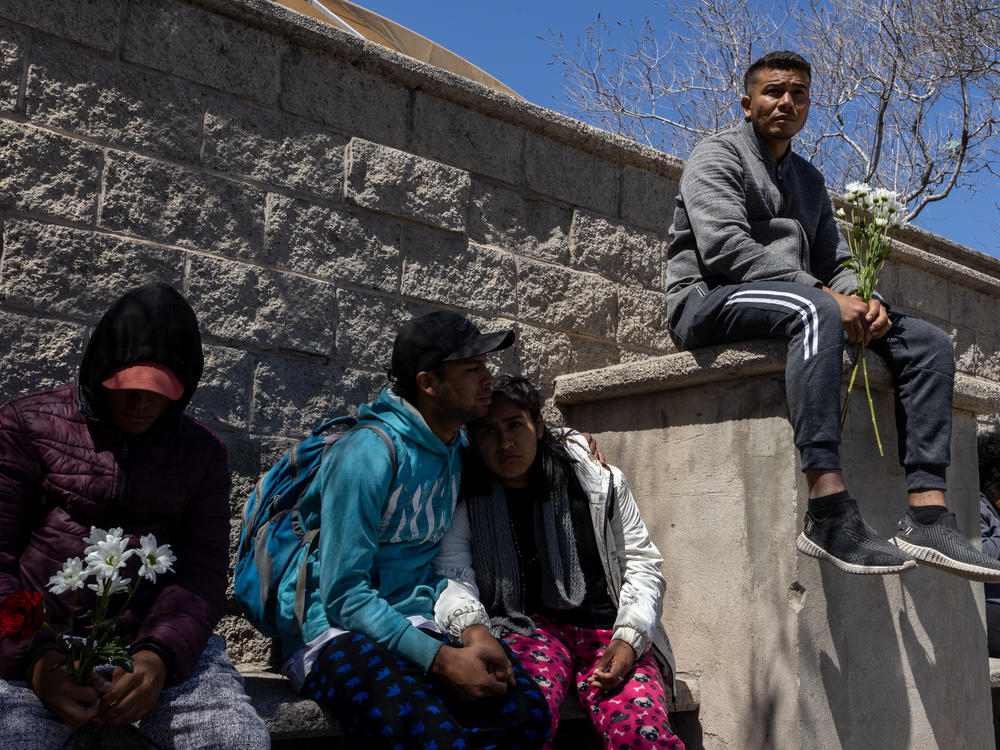 Hundreds of migrants go to a Mexican migration office seeking information about victims of a fire inside a migrant detention center in Ciudad Juárez, Mexico, on March 28.