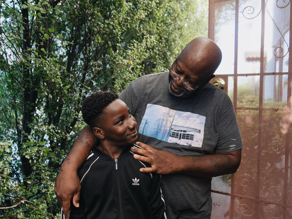 Ziare Gearring (left) and his grandfather Ricky Brown pose for a portrait outside of their home in Los Angeles. The 65-year-old retired handyman had already been struggling, and taking in three grandsons after his ex-wife's sudden death has put him thousands of dollars behind on rent and utilities.