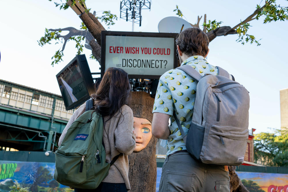 People watch a talking animatronic tree and beaver chat about land and private property, along with a tongue-in-cheek video. The various documentaries and mockumentaries have slogans like, 