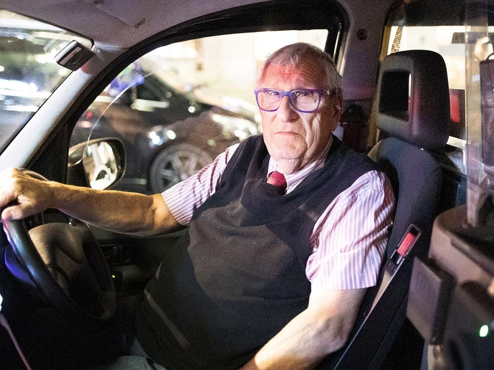 Michael Son sits behind the wheel in his London cab, a job he's had since 1965.