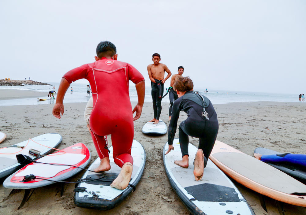 Warm ups on the beach before surfing.