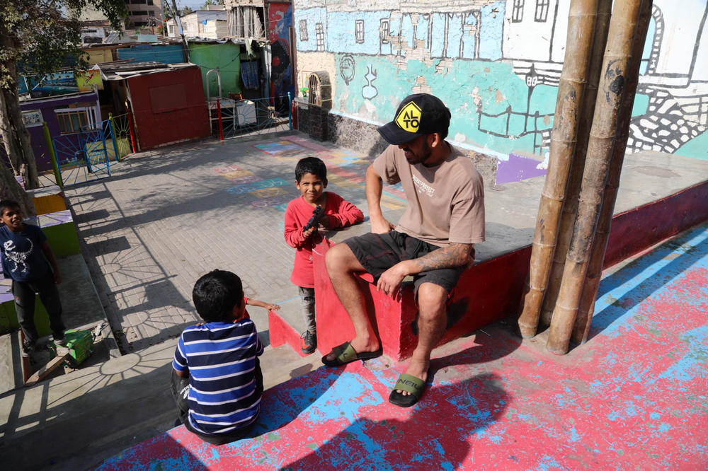 Founder Diego Villarán with kids in a playground built by Alto Peru, the nonprofit group that he heads up.