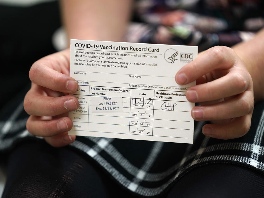 9 year-old Josie Murdoch holds her vaccination card at Chapel Hill Pediatrics and Adolescents after being innoculated with the Pfizer child COVID-19 vaccination in Chapel Hill, N.C., Thursday, Nov. 4, 2021.
