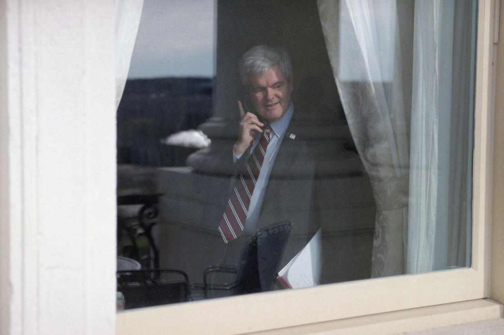 House Speaker Newt Gingrich of Ga., works the phone while peering out the window of his Capitol Hill office on April 4, 1995 in Washington.