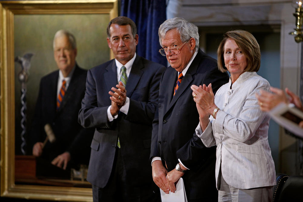 Former Speaker of the House Dennis Hastert (center) is applauded by then-Speaker of the House Nancy Pelosi and then Minority Leader John Boehner during the ceremony unveiling Hastert's portrait at the U.S. Capitol in 2009.