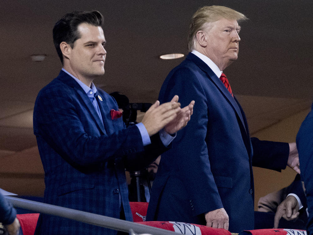 In this Oct. 2019, file photo President Donald Trump, right, accompanied by Rep. Matt Gaetz, R-Fla., left, arrive for Game 5 of the World Series baseball game between the Houston Astros and the Washington Nationals at Nationals Park in Washington.