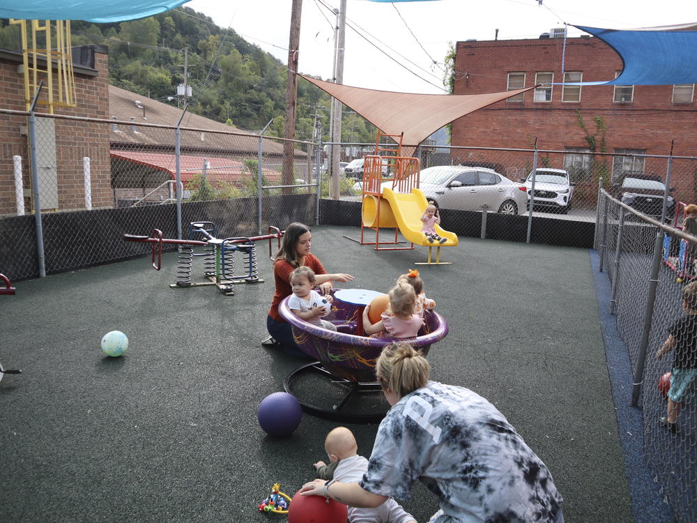 Staff and toddlers play at a daycare in Williamson, W.Va., in September.