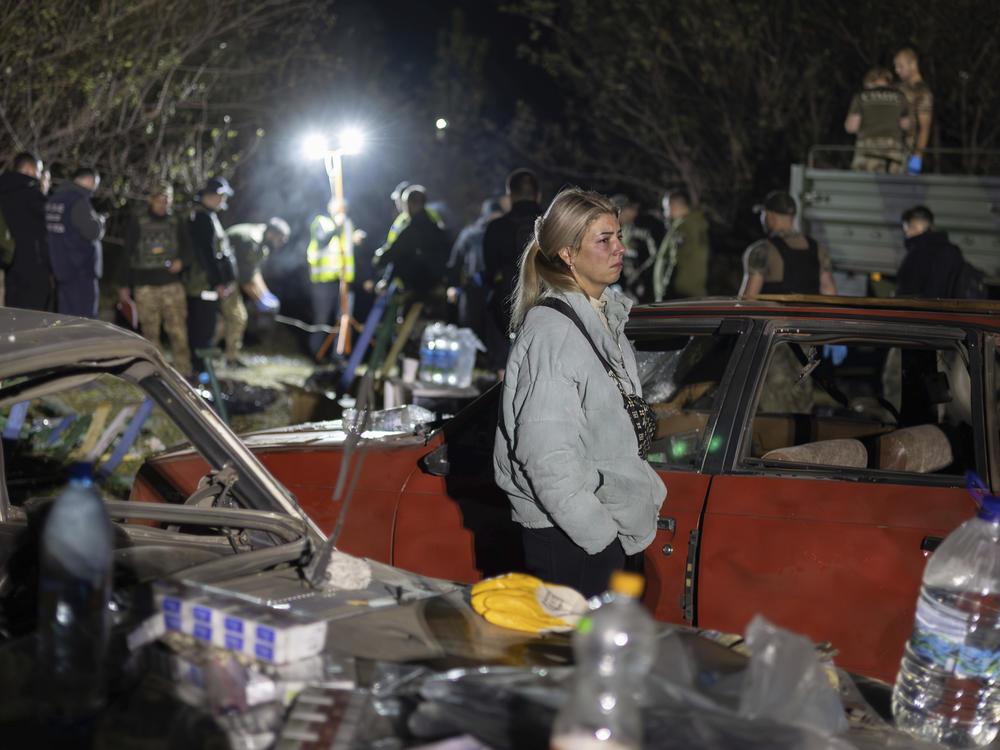 Lida Nechvolot, who lost her step-father reacts at the place of a Russian rocket attack that killed 51 people in the village of Hroza near Kharkiv, Ukraine, Thursday, Oct. 5, 2023.