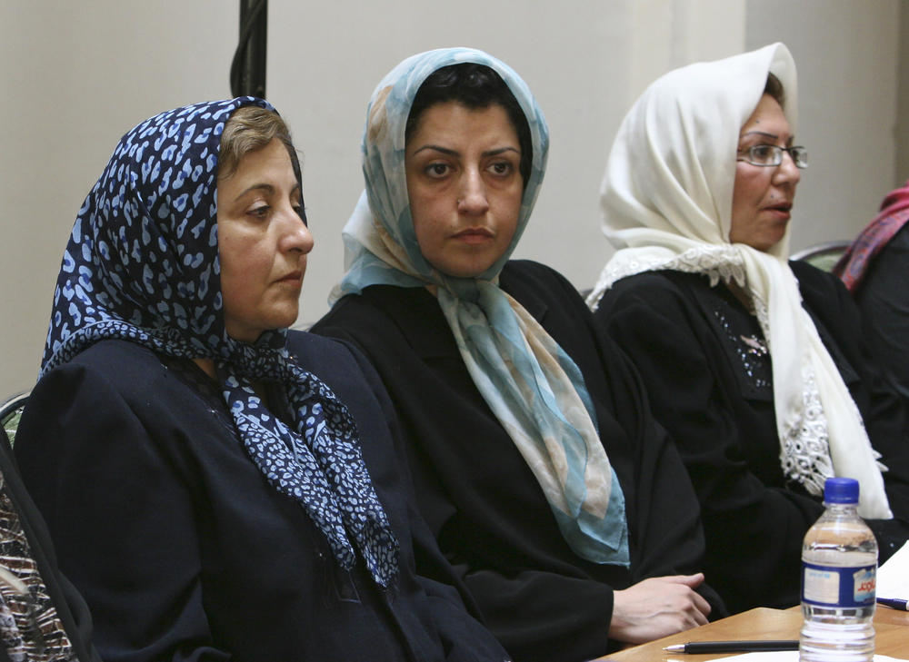 FILE - Prominent Iranian human rights activist Narges Mohammadi, center, sits next to Iranian Nobel Peace Prize laureate Shirin Ebadi, left, while attending a meeting on women's rights in Tehran, Iran, on Aug. 27, 2007.