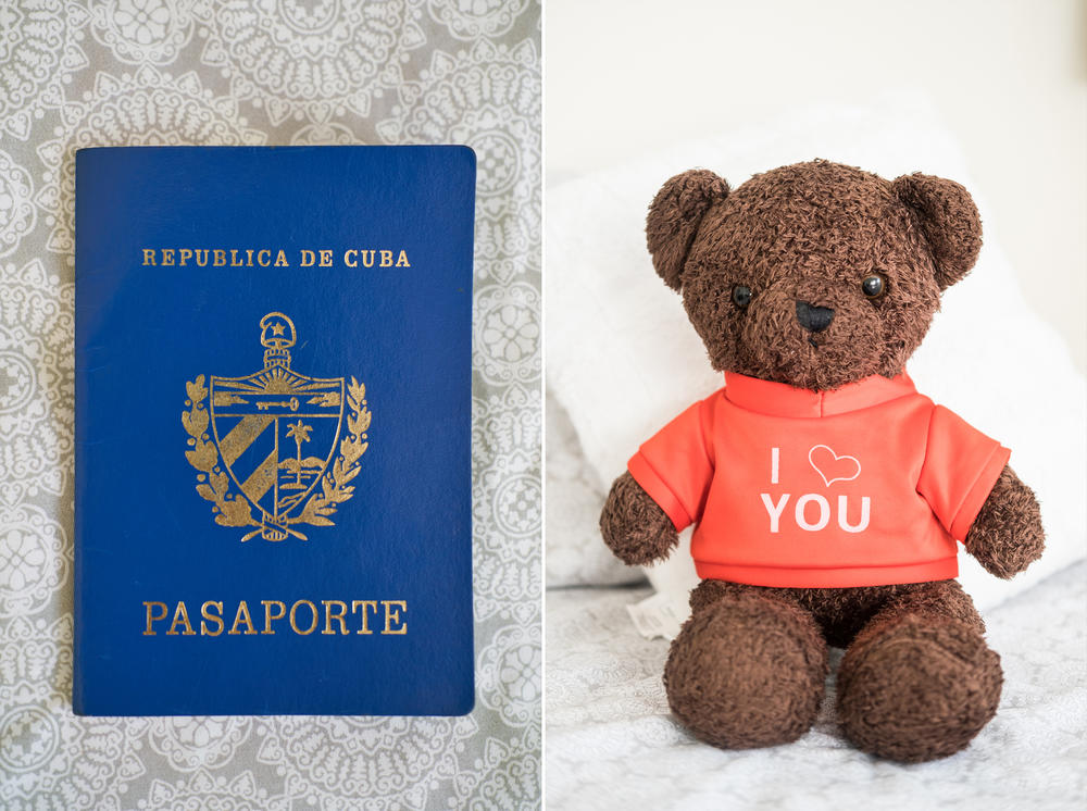 Yossell's Cuban passport is resting on the couch in his home in Tampa, Florida. A teddy bear wearing a shirt that reads 
