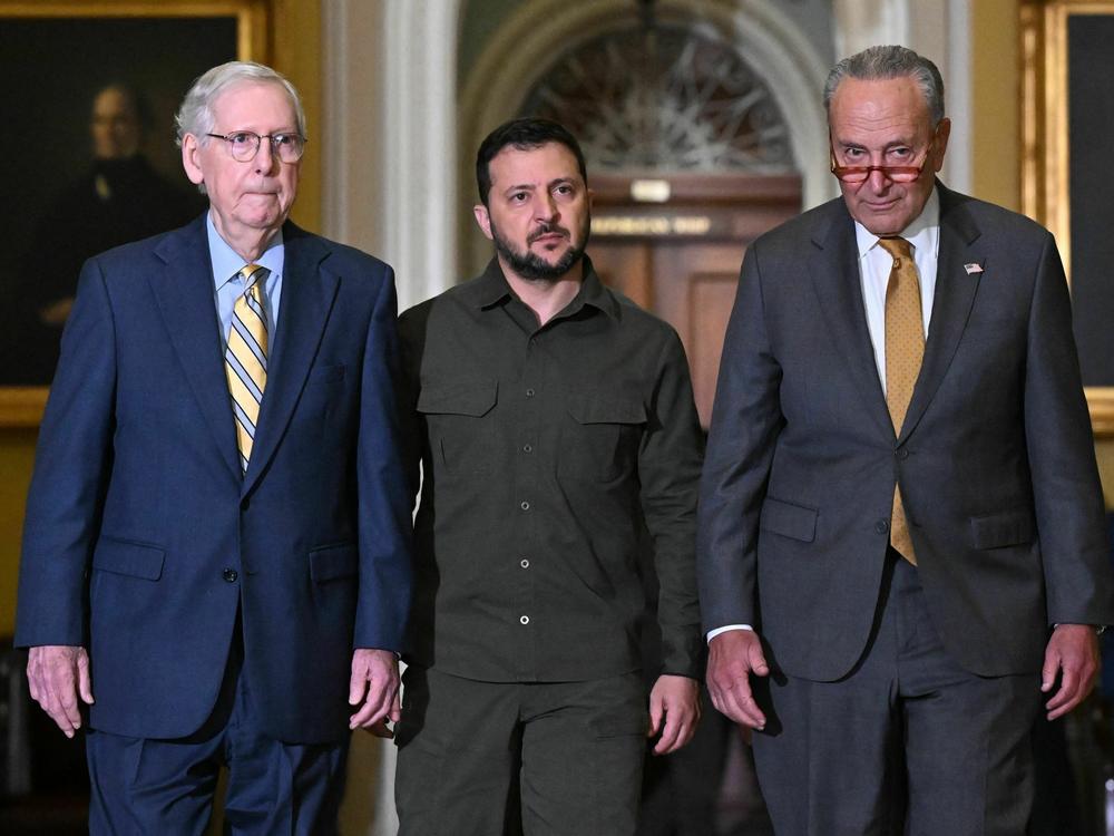 Ukrainian President Volodymyr Zelenskyy (center) walks with Senate Majority Leader Chuck Schumer, D-N.Y., and Senate Minority Leader Mitch McConnell, R-Ky., during a trip to Washington last month.