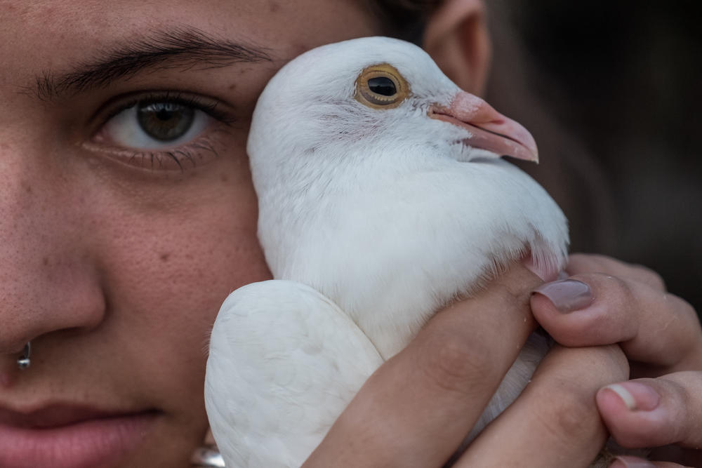 Laura poses for a portrait on the roof of her house in Havana. She hopes to see her sister again one day: 