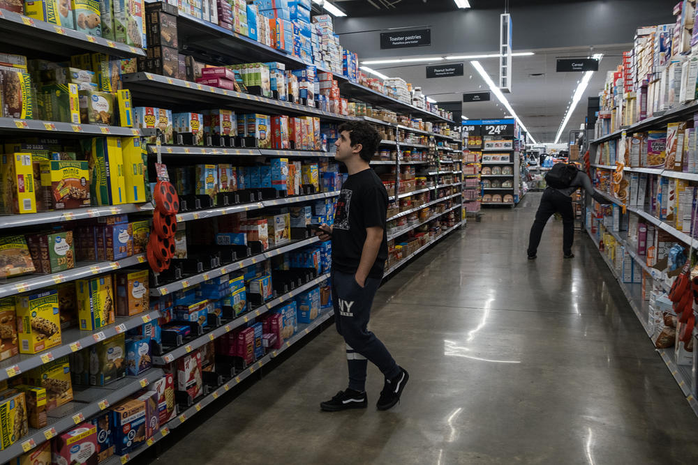 Jan looks at the shelves full of cornflakes in a supermarket in Tampa. The abundance contrasts with his life in Cuba, where 