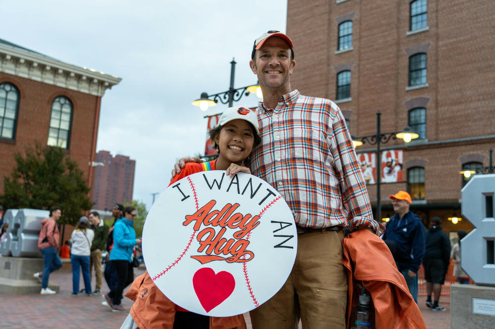 Peter Bolster and his child Mai attend the Orioles game in Baltimore on Sept. 26.