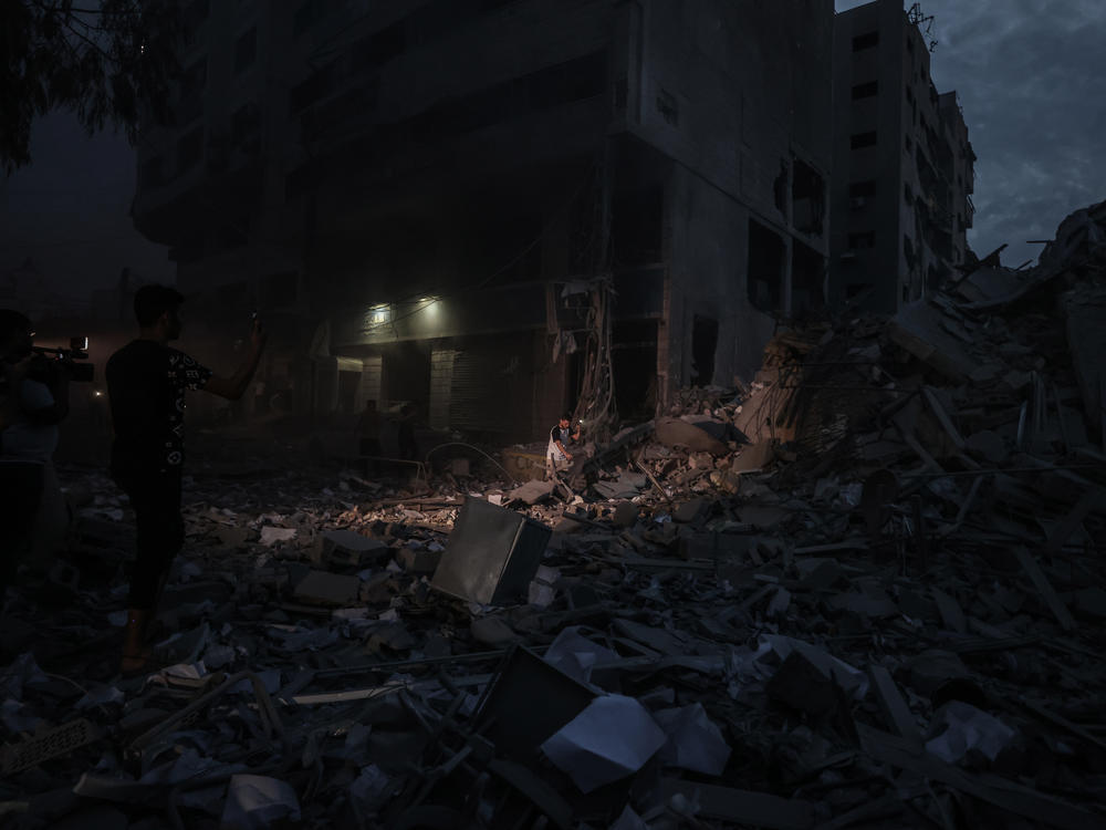Sat., Oct. 7: Palestinians inspect the destroyed buildings after a rocket attack by Israeli air forces targeting a shopping center in the Gaza Strip, Gaza.
