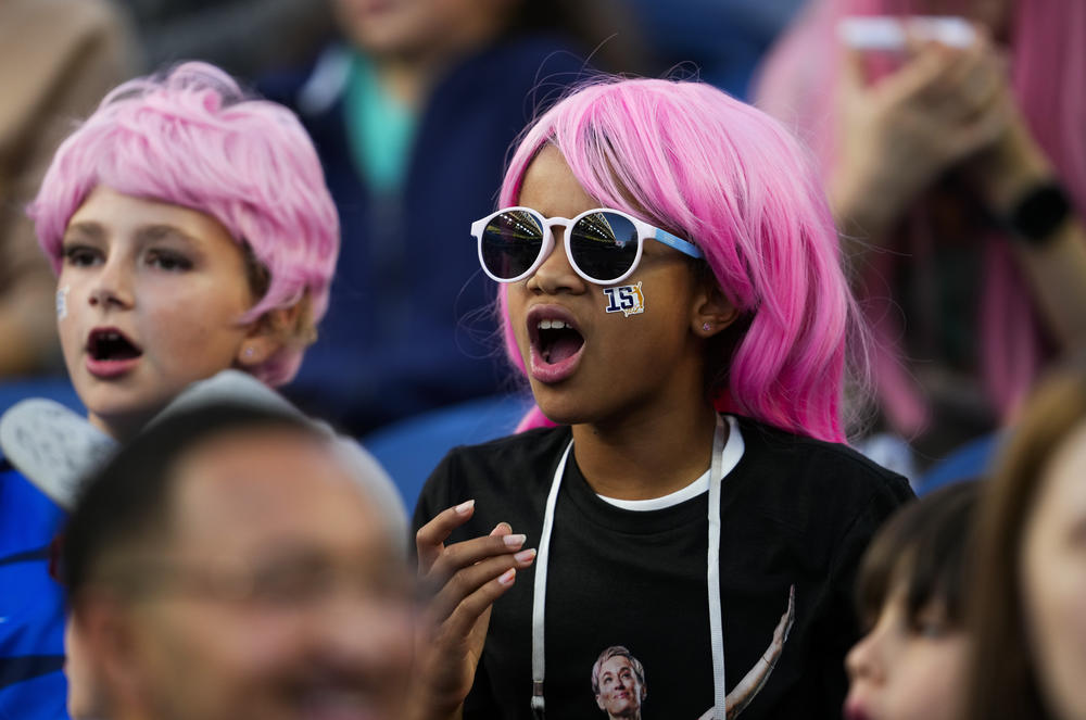 Fans wear pink wigs and stickers with the number of OL Reign forward Megan Rapinoe during the first half of an NWSL soccer match between the Reign and the Washington Spirit, Friday, Oct. 6, 2023, in Seattle.