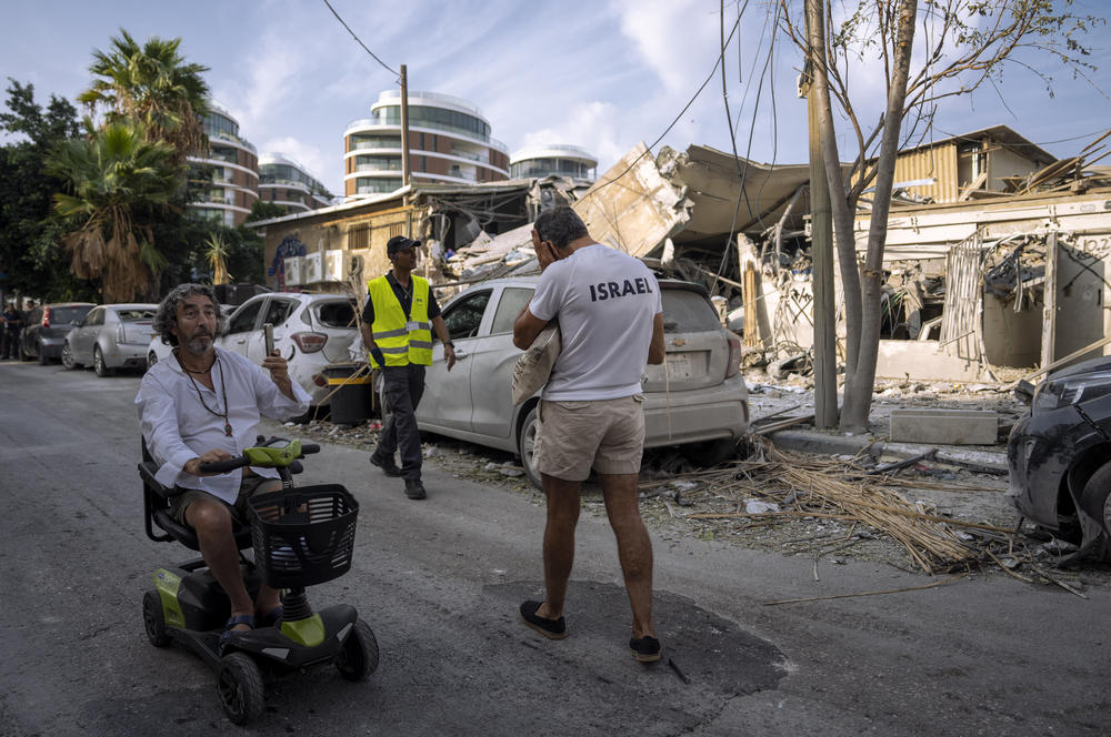 Sun., Oct. 8: Israelis inspect the rubble of a building a day after it was hit by a rocket fired from the Gaza Strip, in Tel Aviv, Israel.