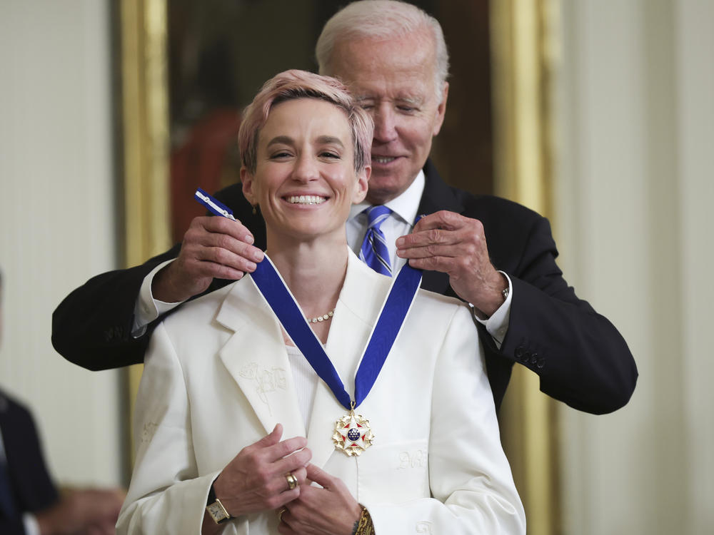 President Joe Biden presents the Presidential Medal of Freedom to Megan Rapinoe, soccer player and advocate for gender pay equality, during a ceremony in the East Room of the White House on July 7, 2022.