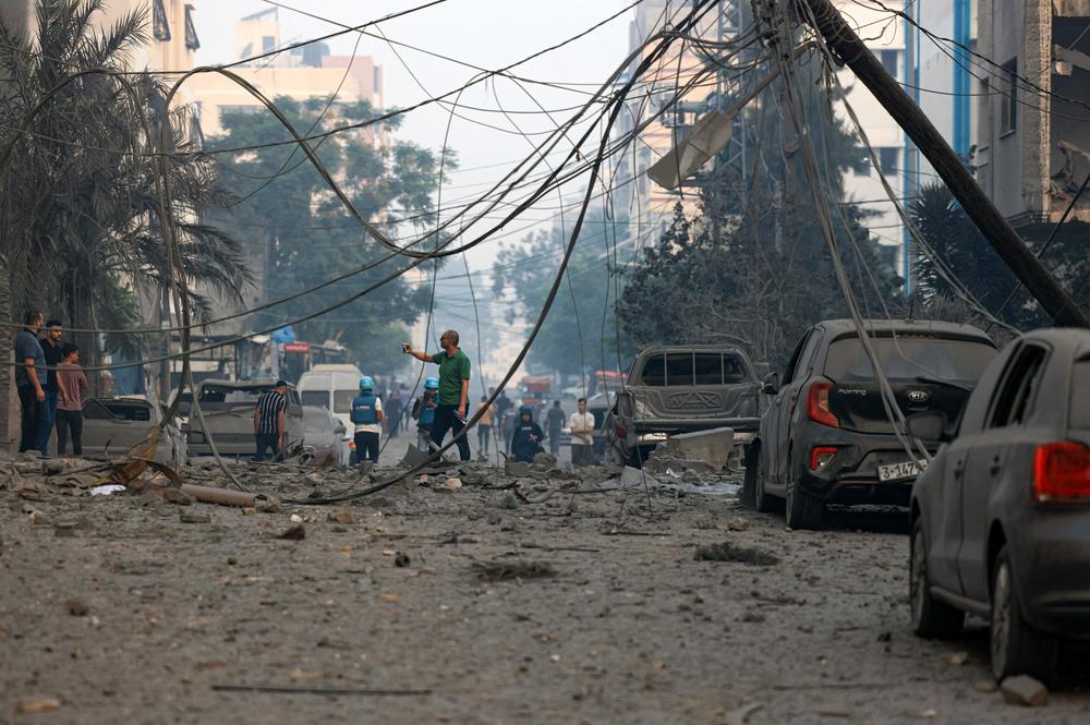 Sun., Oct. 8: Residents check the damage following Israeli air strikes in Gaza City.