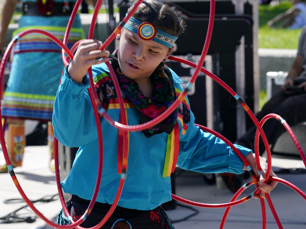 A performer from the Native American Hoop Dance of Ballet Arizona dances at an Indigenous Peoples Day festival Monday, Oct. 9, 2023, in Phoenix.