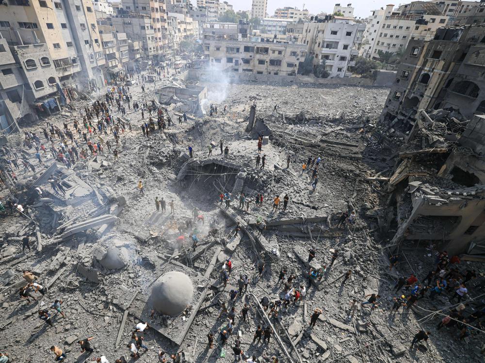 Palestinians inspect the damage following an Israeli airstrike on the Sousi mosque in Gaza City on Monday.