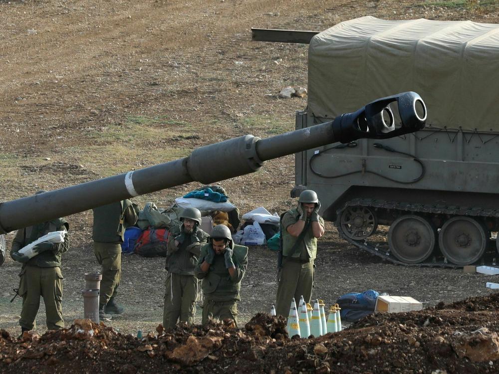 Israeli forces launch artillery fire toward southern Lebanon from the border zone in northern Israel on Monday, while Hezbollah denied involvement in clashes or 