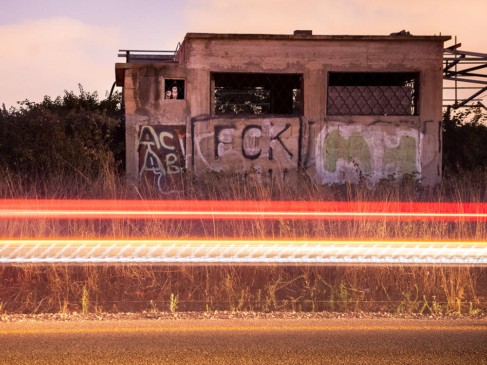 <strong>15-17 Years Winner:</strong> <em>Owls' road house. </em>Hof HaSharon, Israel. The photographer snapped this shot of several barn owls in the window of an abandoned building, using long exposure times to capture the light of passing traffic.