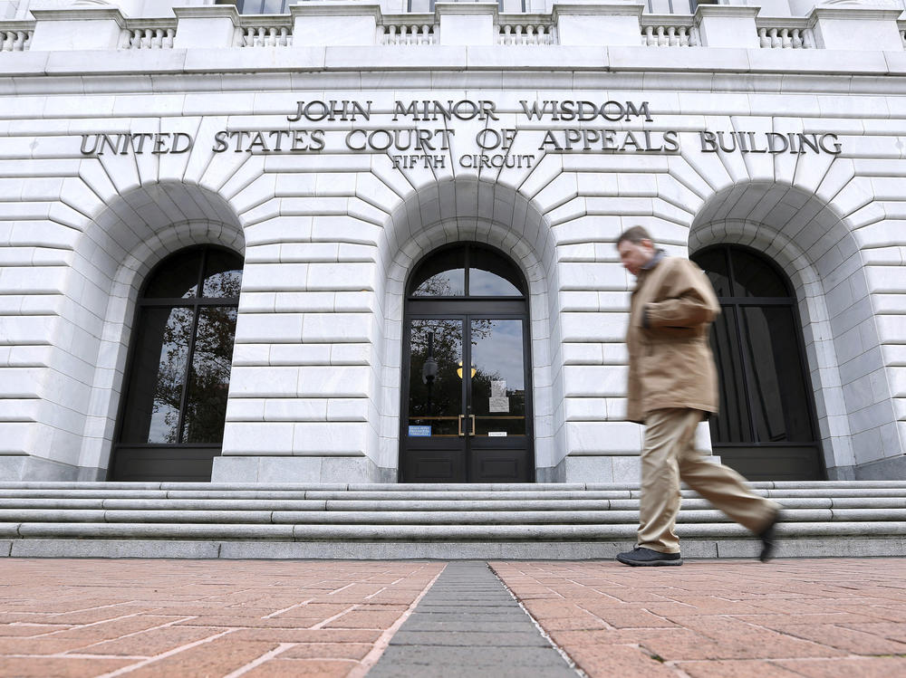 A person walks in front of the 5th U.S. Circuit Court of Appeals in New Orleans in 2015.