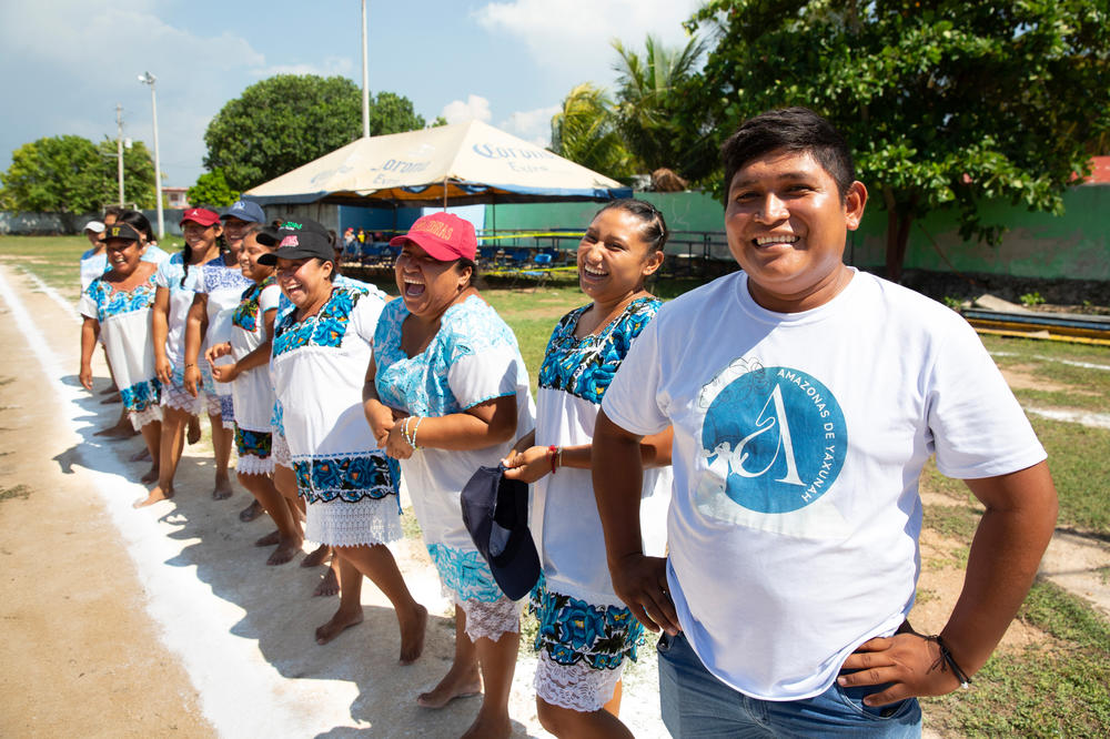 The manager of the Amazonas of Yaxunah, Joel Almícar Diaz Canul stands with the team before a July 1 match.