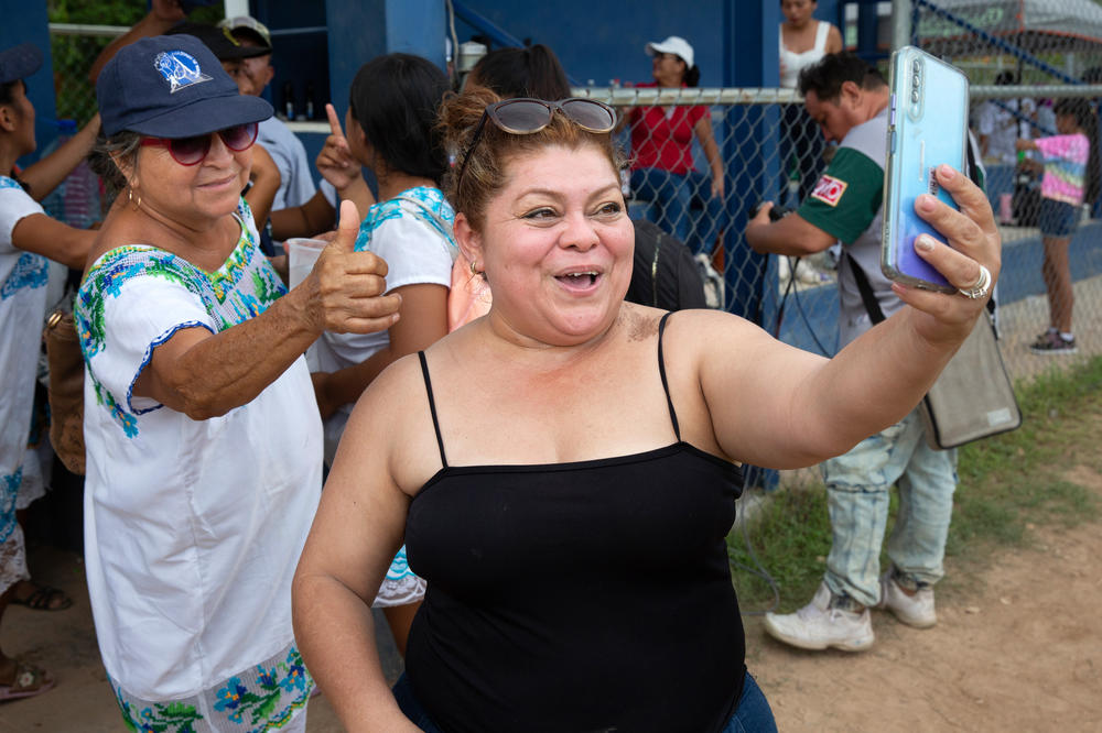 A fan takes a selfie with Juana Maria Concepción Moo Oxté, 62, of the Amazonas of Yaxunah. A viral video of the team helped launch them to national fame.