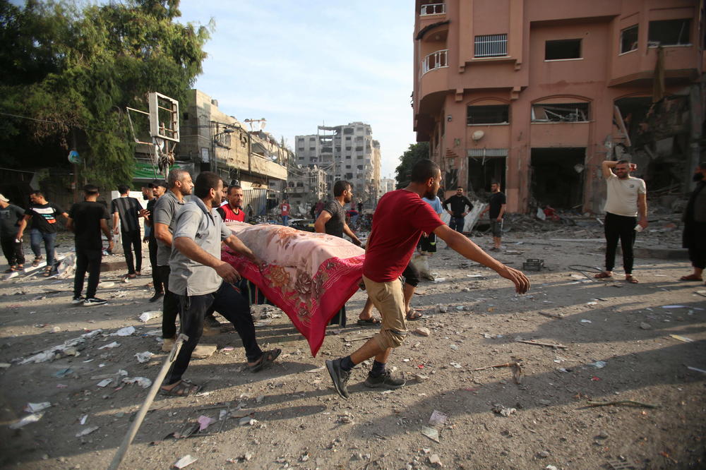 Palestinian families search for safer areas after overnight Israeli shelling in Gaza City, Wednesday.