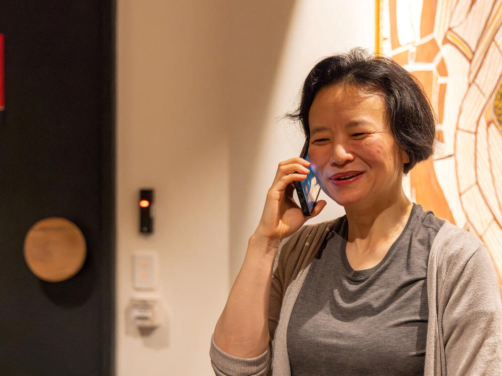 Australian journalist Cheng Lei speaks on the phone, on arrival at Melbourne Airport in Melbourne, October 11, 2023.