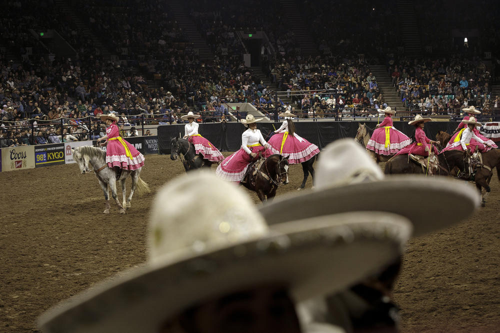 Escaramuza Flor de Aguileña perform a sidesaddle synchronized routine for the audience.