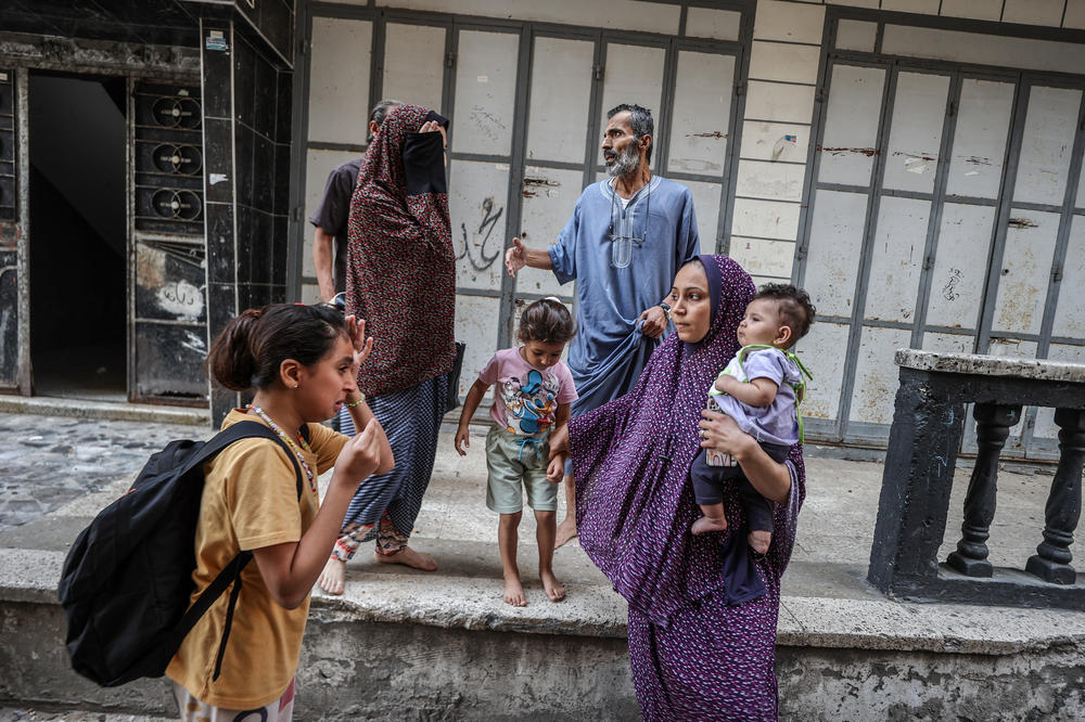 A girl cries as people leave their houses due to Israeli airstrikes for a fifth day, in Gaza City on Wednesday.