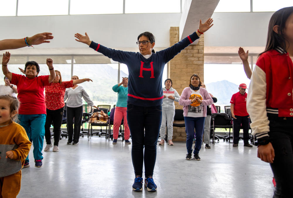 Infante, standing center, has been a full-time family caregiver for nearly a decade. She says that the dance and cardio classes are the only chance she has to exercise and meet other caregivers in the community.