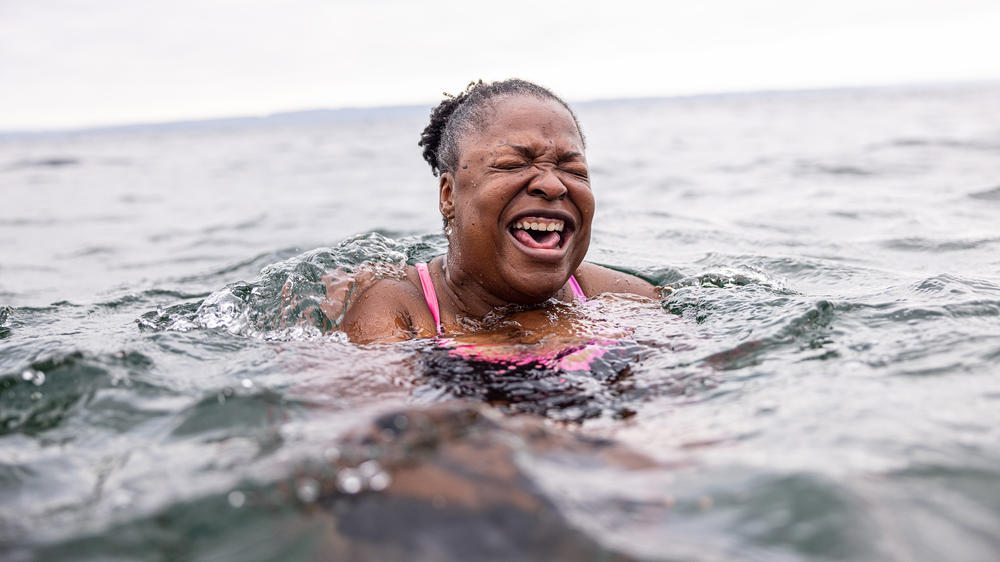 Mikki Smith lets out a cry as she adjusts to the frigid water. It was her first time with the Puget Sound Plungers in Seattle, Washington.