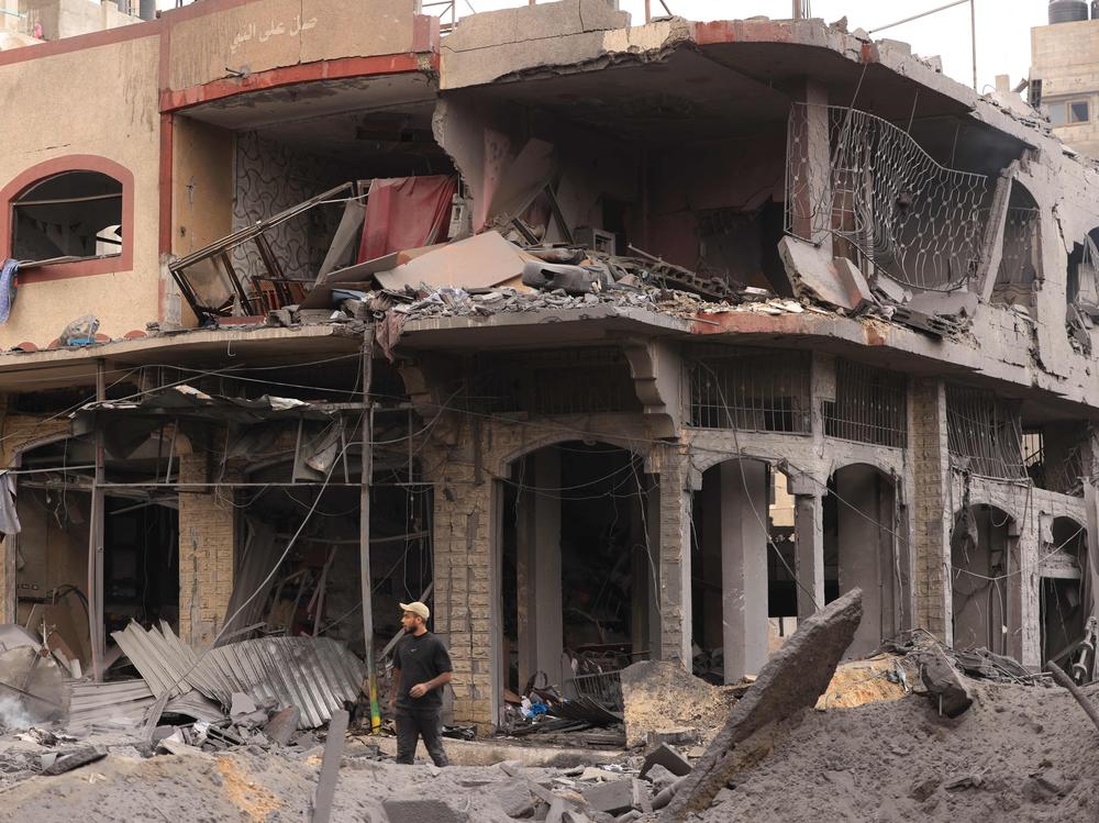 A young Palestinian walks through rubble in a heavily bombarded neighborhood following overnight Israeli airstrikes on Gaza City's Shati refugee camp early on Monday.