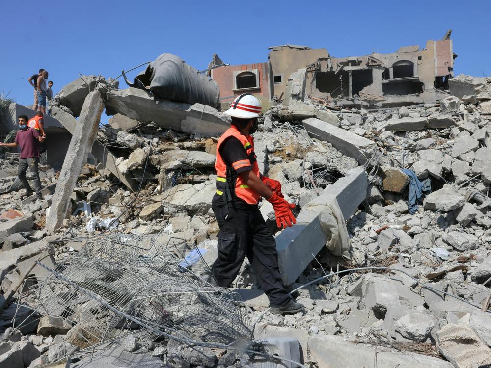 Palestinian rescuers search the rubble of destroyed buildings in Rafah, in the southern Gaza Strip, on Thursday.