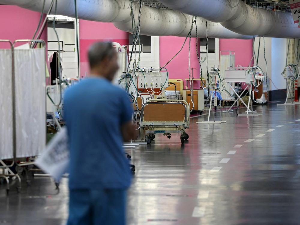 A man walks through a makeshift emergency underground hospital in the parking lot of the Rambam Health Care Campus (RHCC) in Haifa in northern Israel.