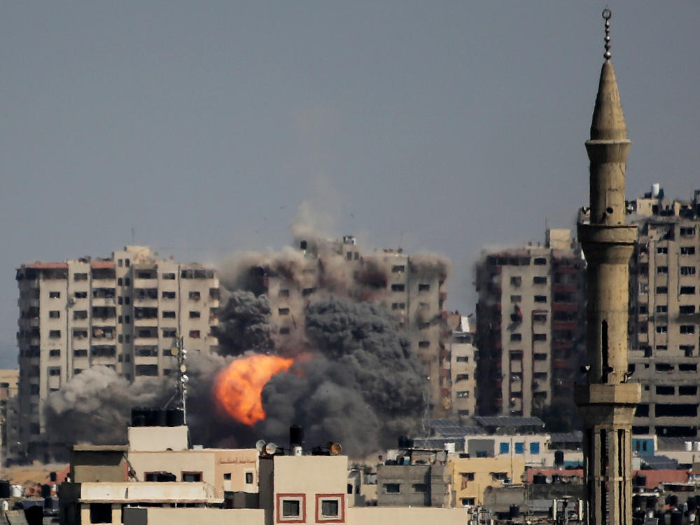 Israeli forces strike a residential tower in Gaza City on Thursday.
