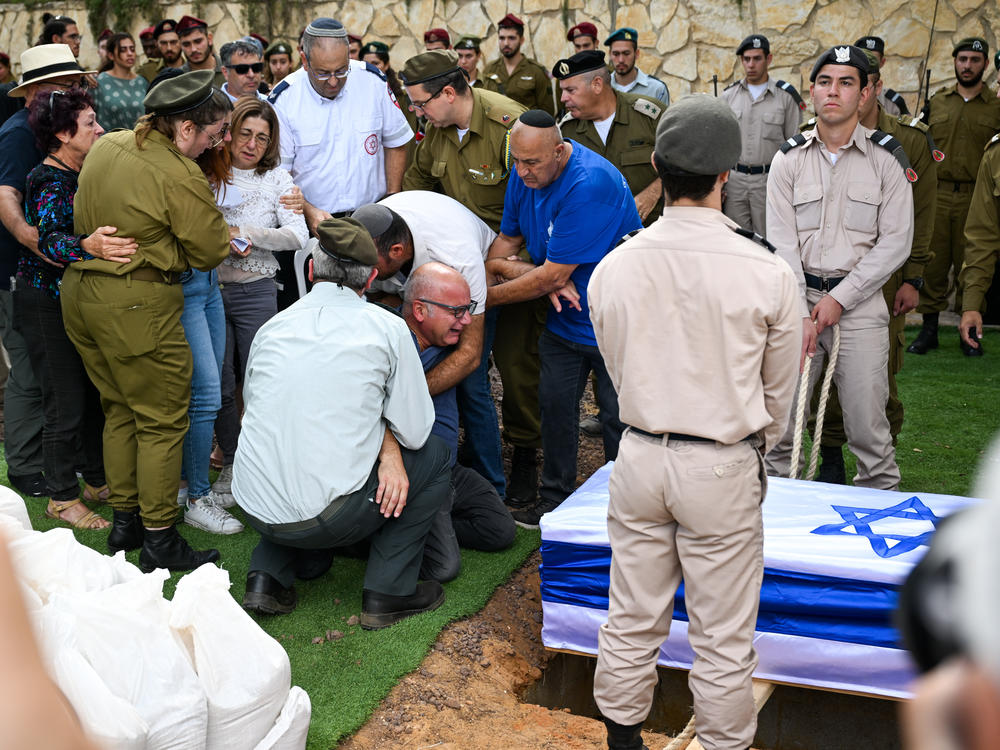 The family of an Israeli soldier killed by Hamas militants cries at his funeral on Thursday.