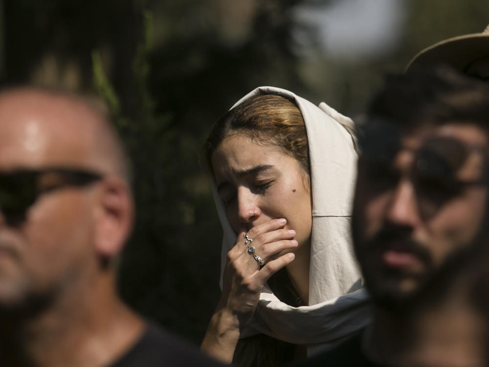 Family and friends of May Naim, 24, who was killed by Palestinian militants at the 