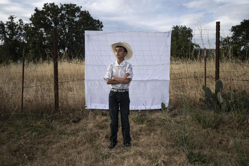 Carlitos, Kevin's youngest brother, poses for a portrait at Kevin's birthday party in June 2023.